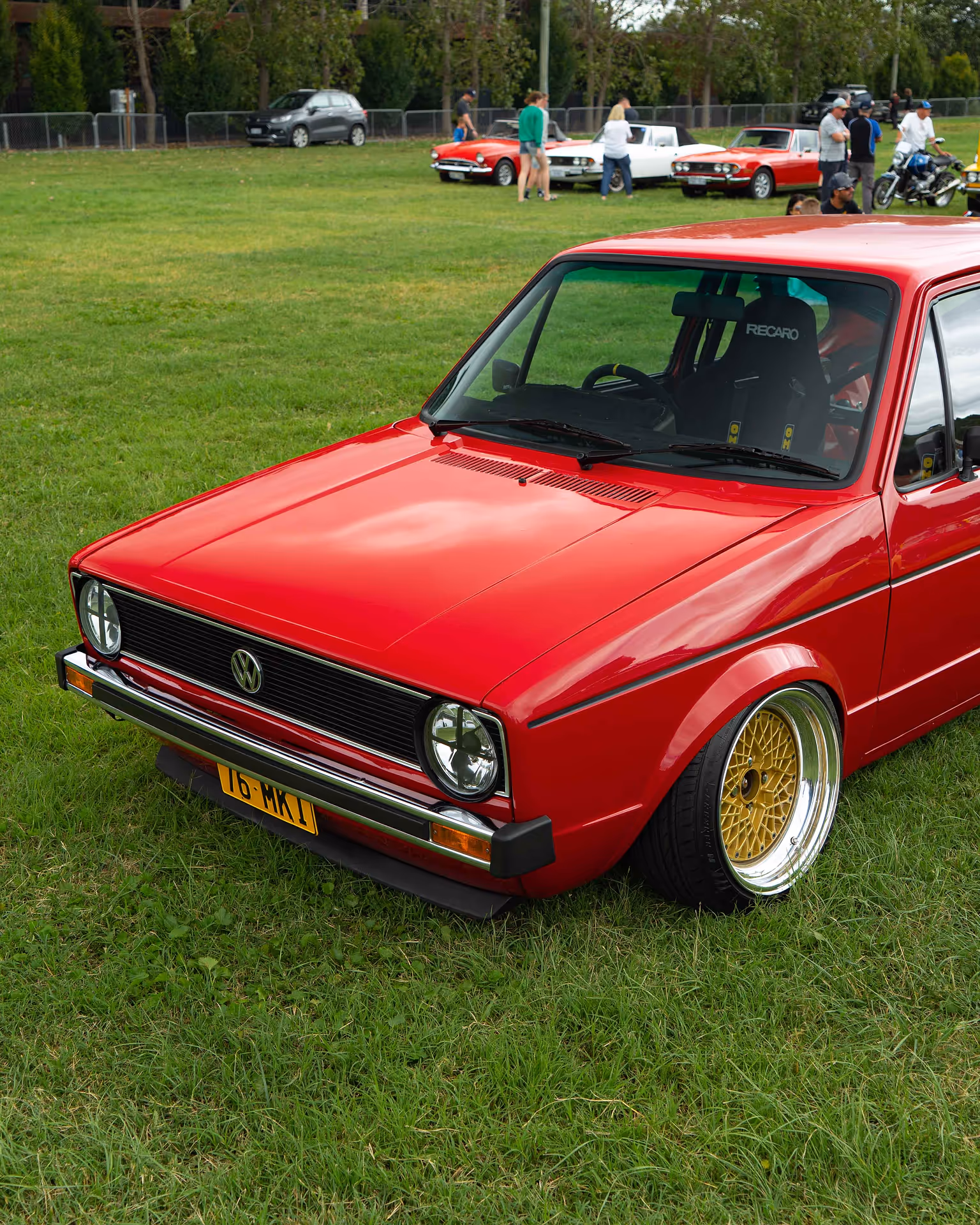 A red car parked on grass