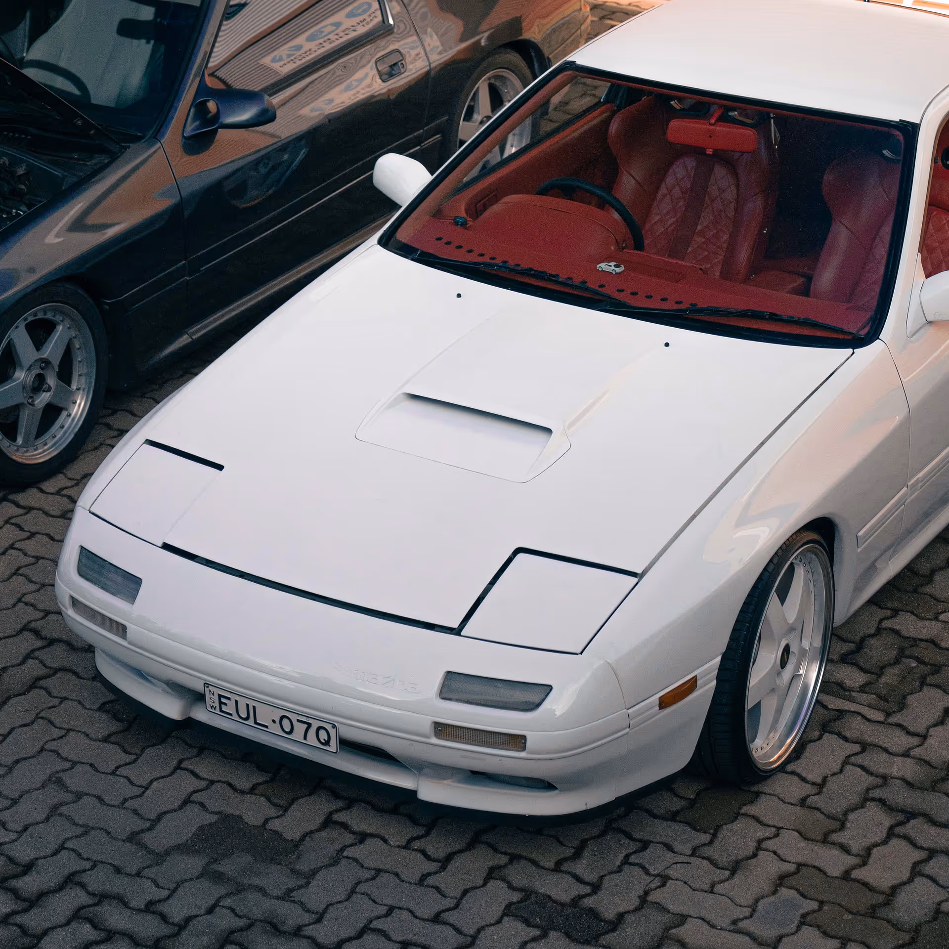 Front of a white car with red interior seats